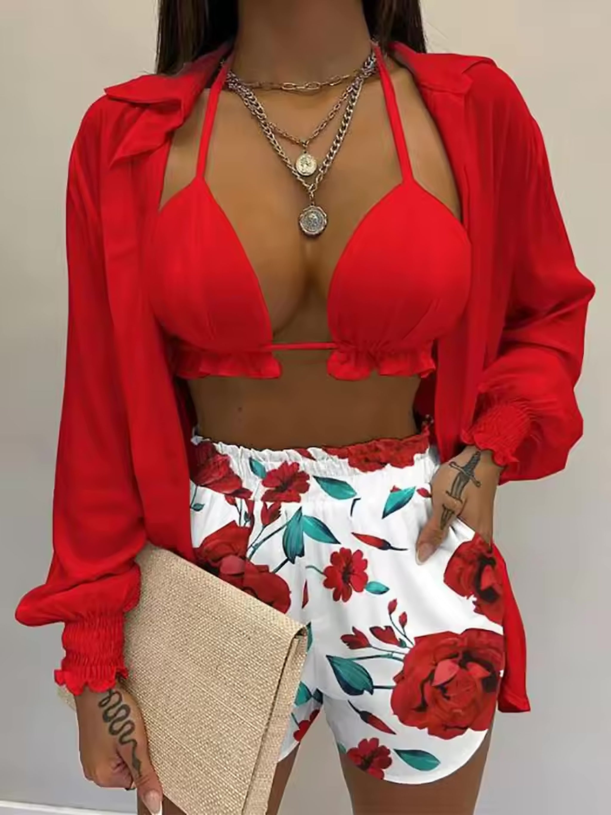 Red halter bikini top with floral swim shorts and matching red shirt jacket
