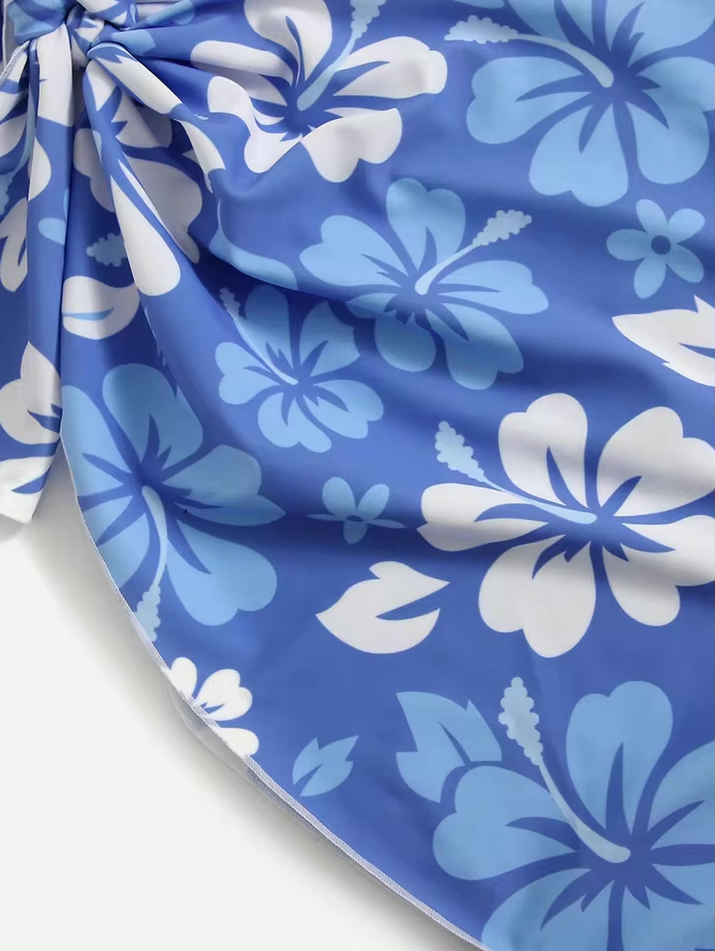 Blue and white floral print bikini with layered botanical design and adjustable ties