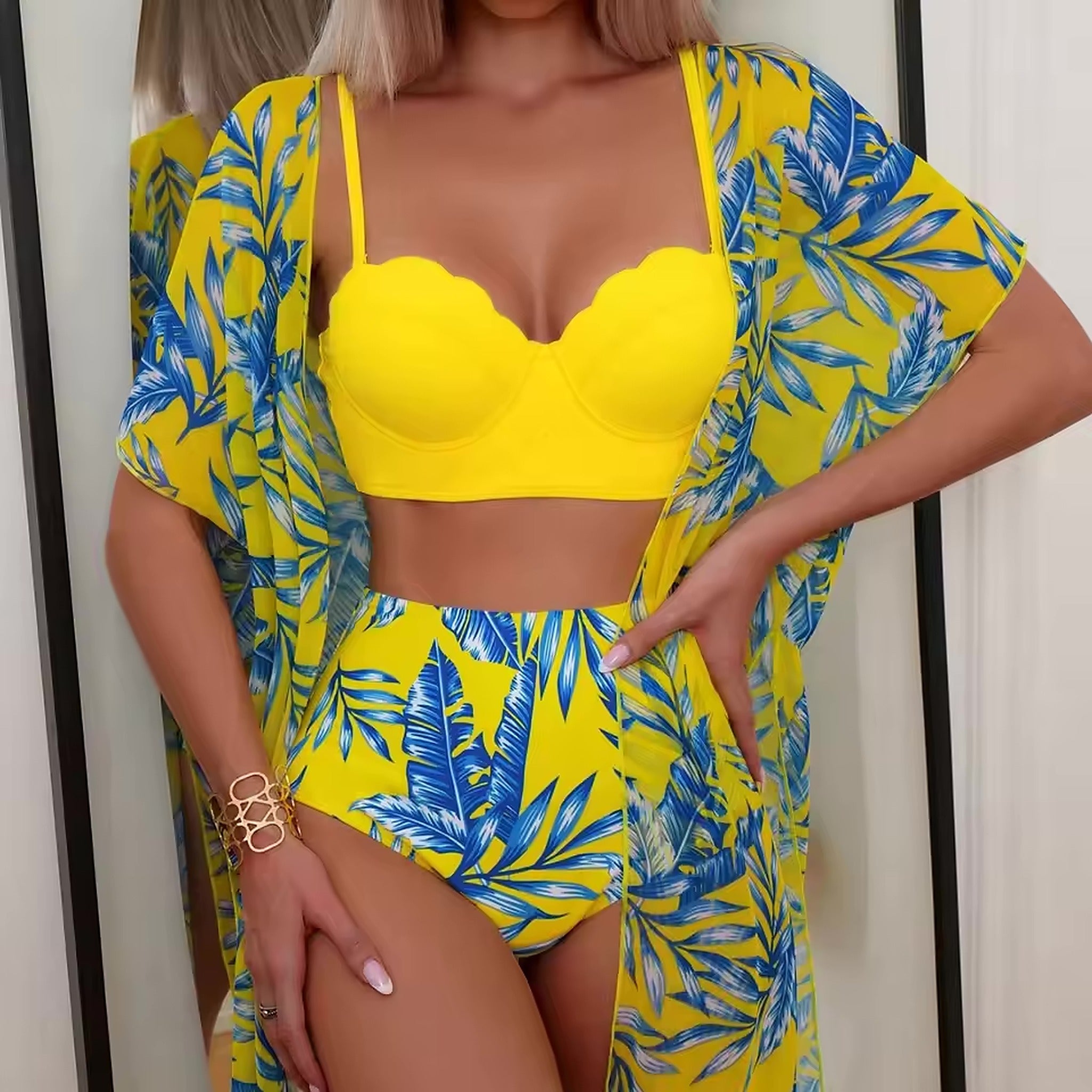 Woman wearing yellow bikini with blue leaf print and matching cover-up robe, Shadow Flame design.