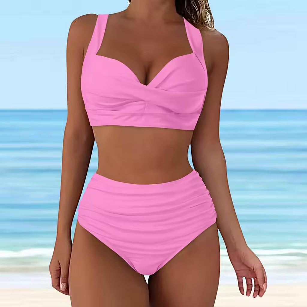 Pink ruched bikini set with sweetheart neckline and high-waisted bottom on beach background